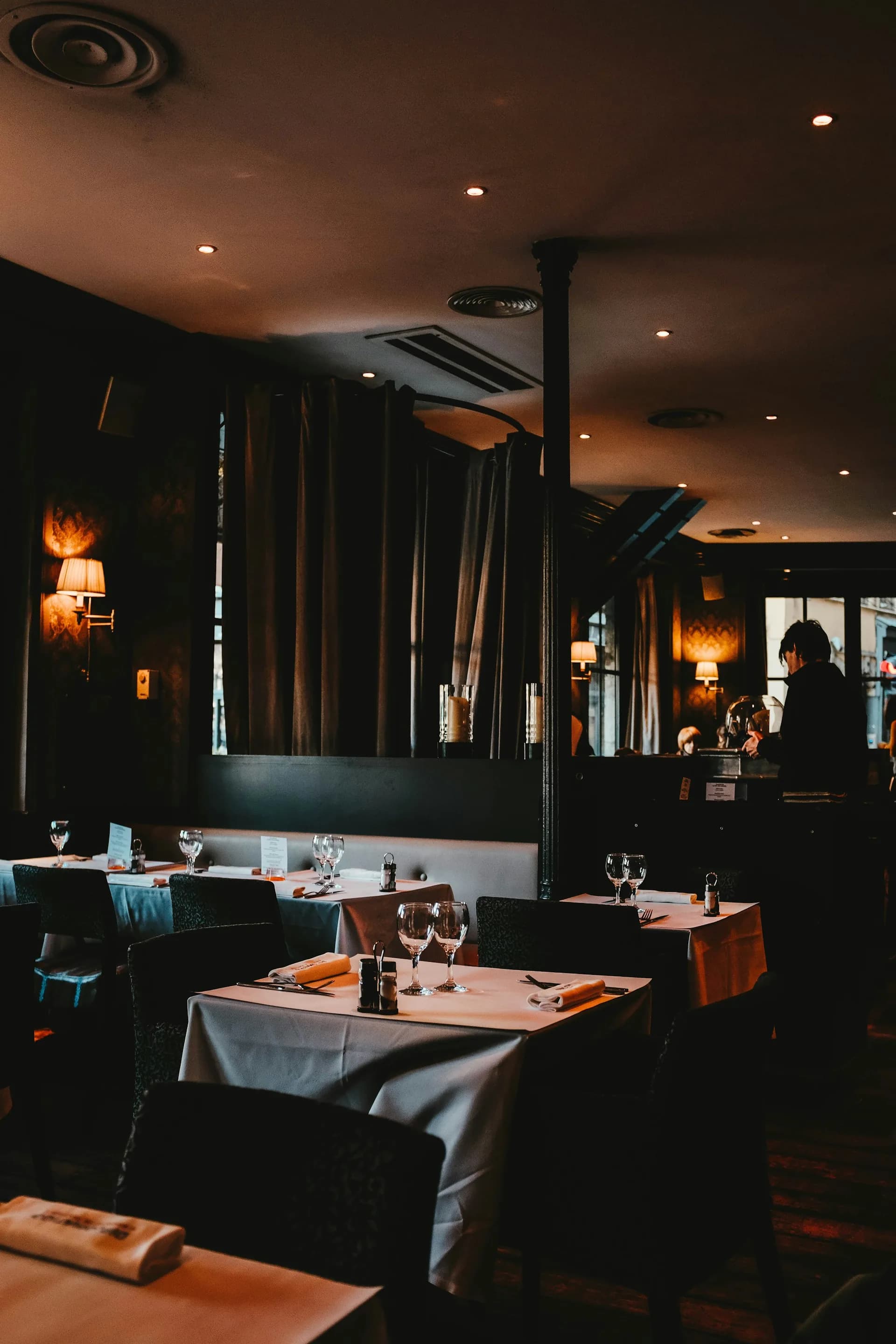 A warmly lit Randalls dining room set for the evening